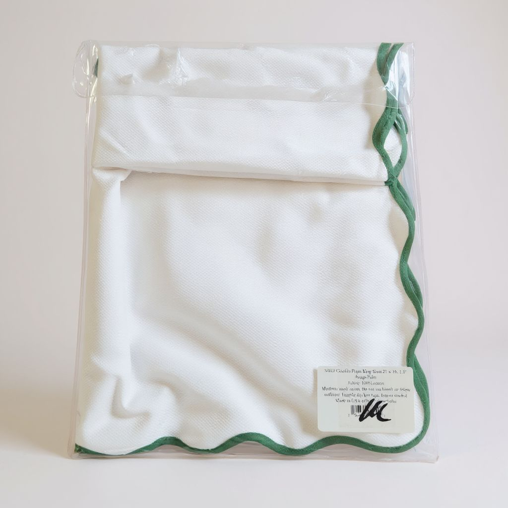 White drawstring bag with green trim on a white background
