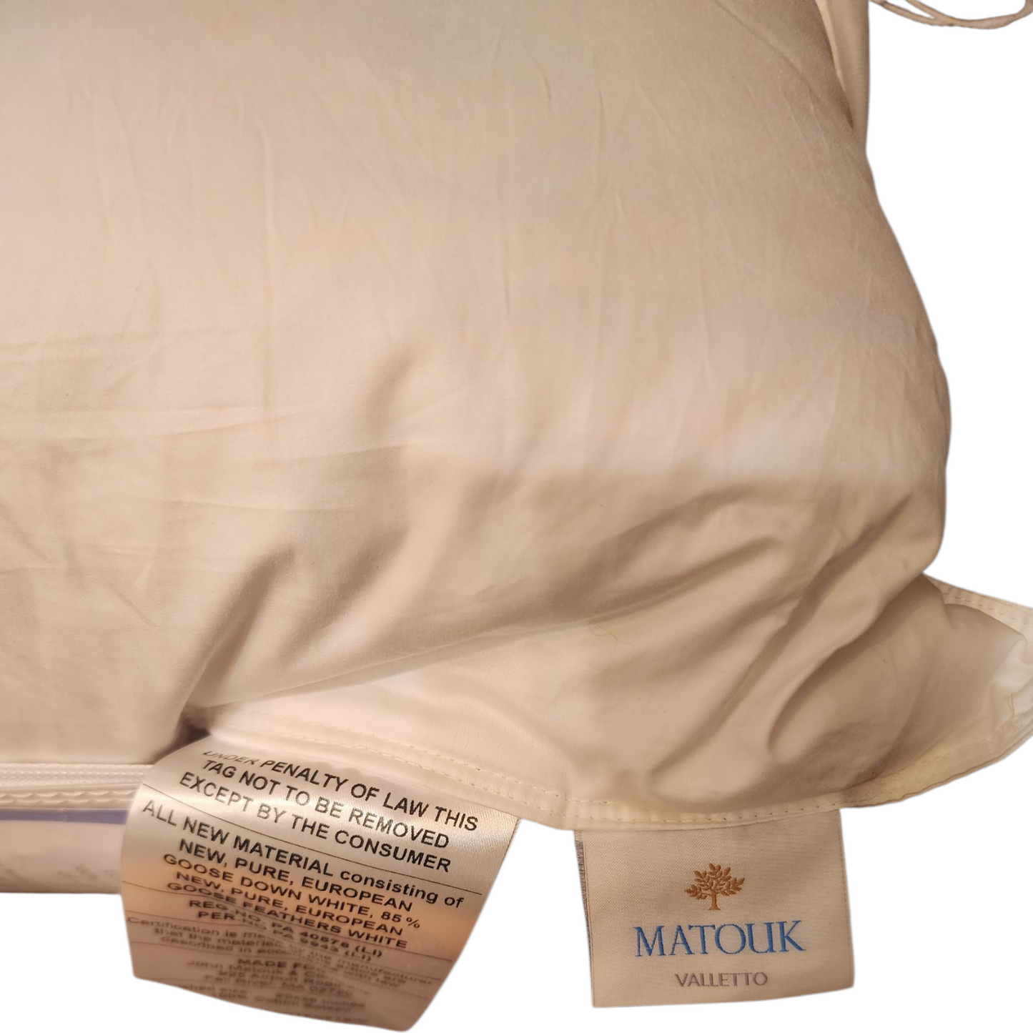 White pillow with a visible brand label on a white background