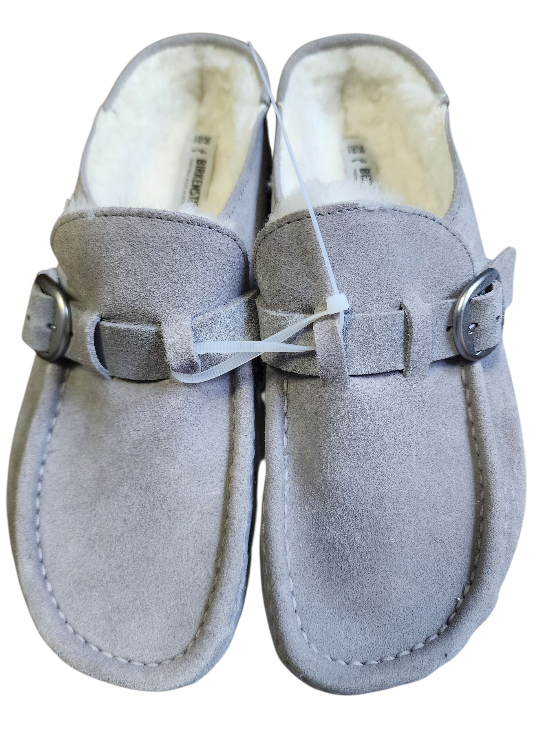 Pair of gray slippers with buckle details on a white background