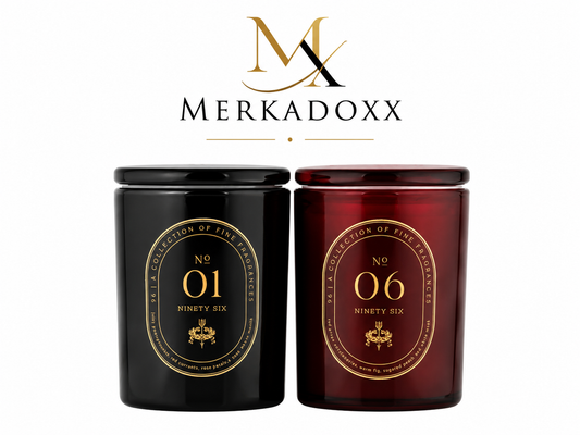 Two candles, one black and one red, with gold labels featuring numbers and branding on a white background.
