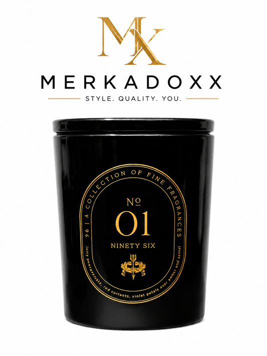 Black candle with gold label featuring Merkadoxx branding on a white background