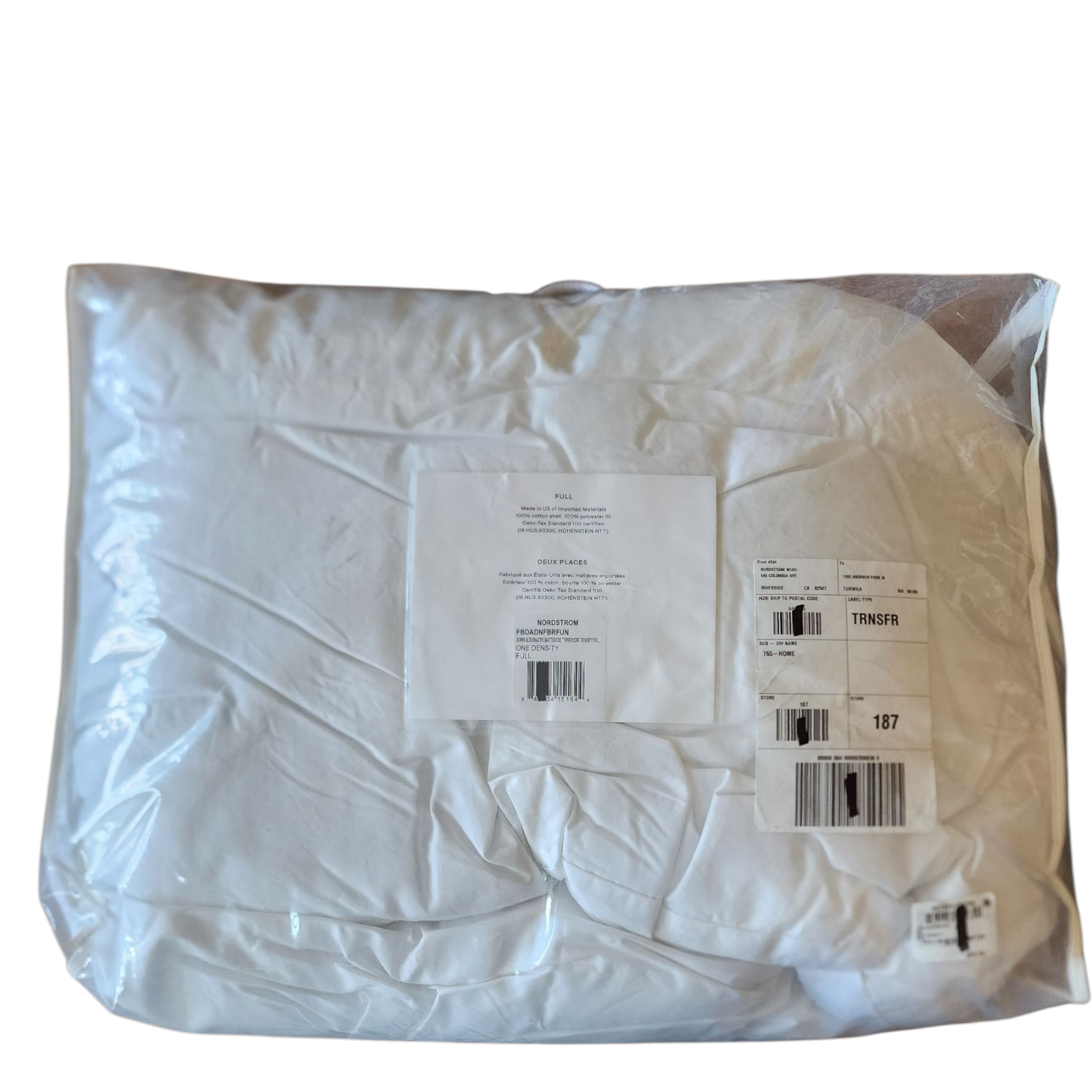 White Mattress topper  in a clear plastic bag with labels on a white background