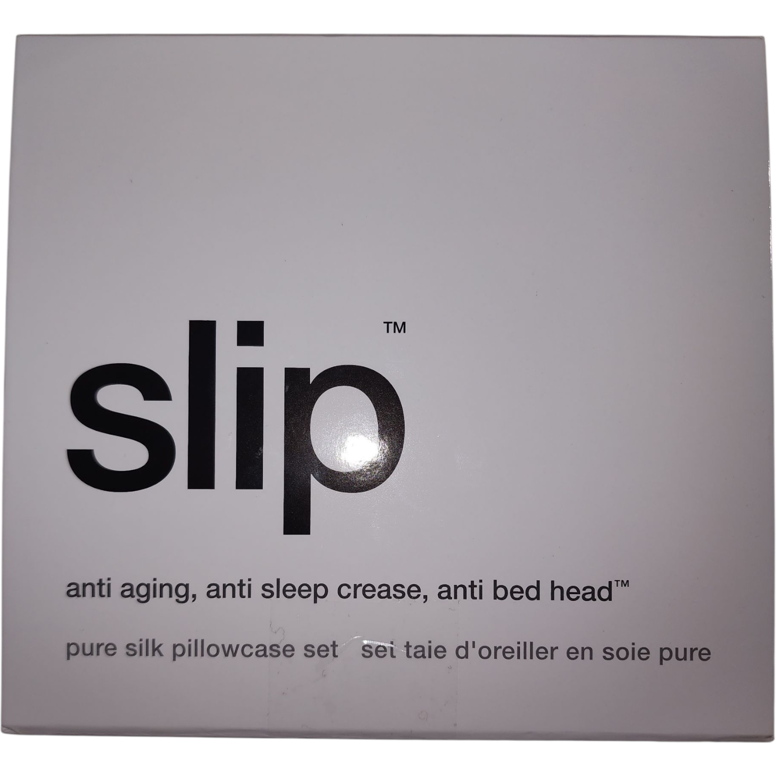 Box of slip pure silk pillowcase set with text on a gray background