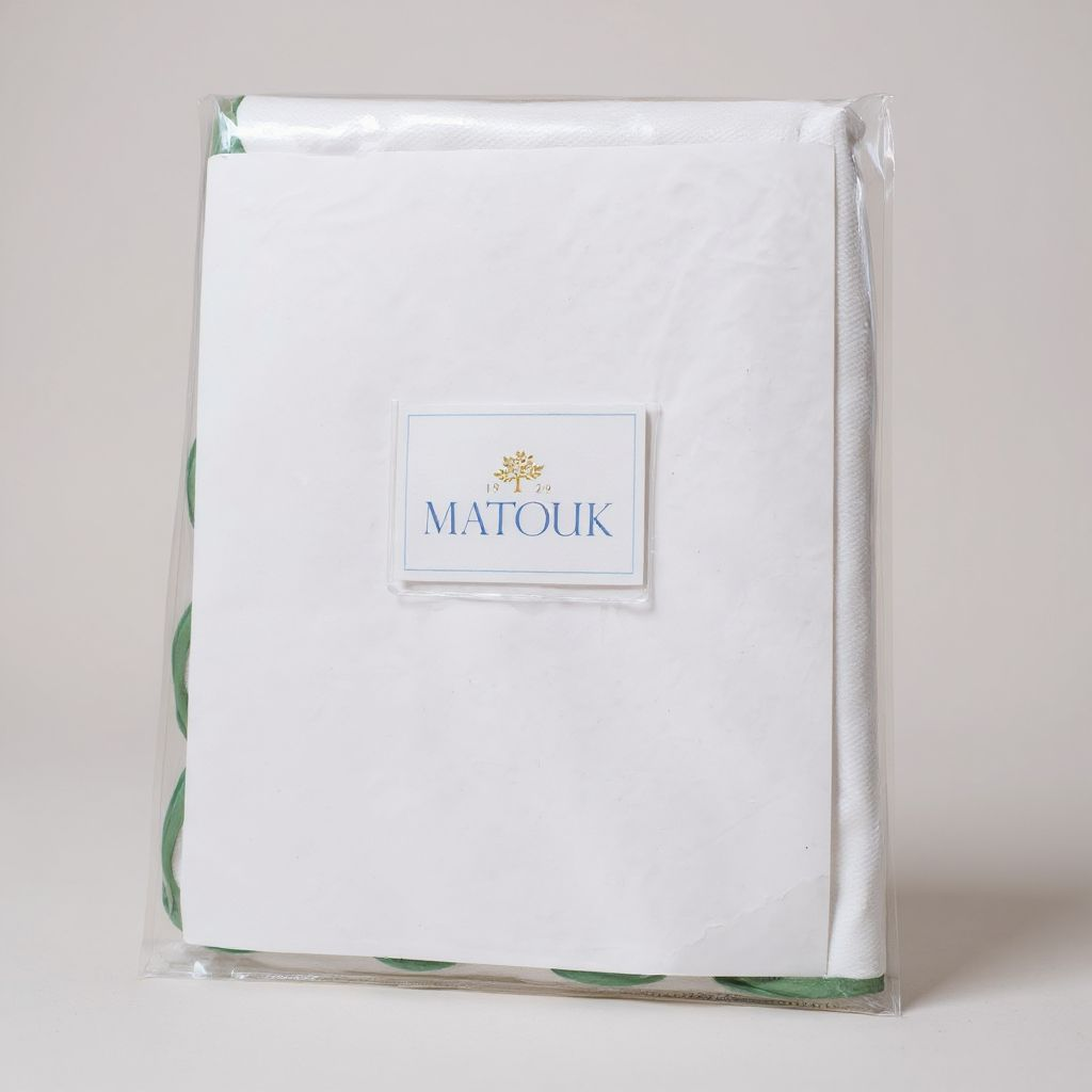 Packaged Matouk bed sheet set on a light background