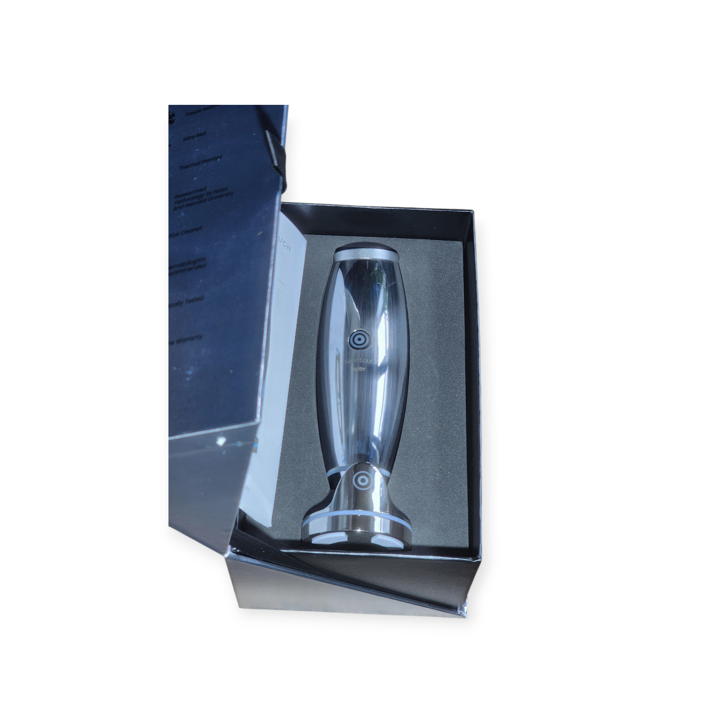 Silver cylindrical object in a black box on a white background