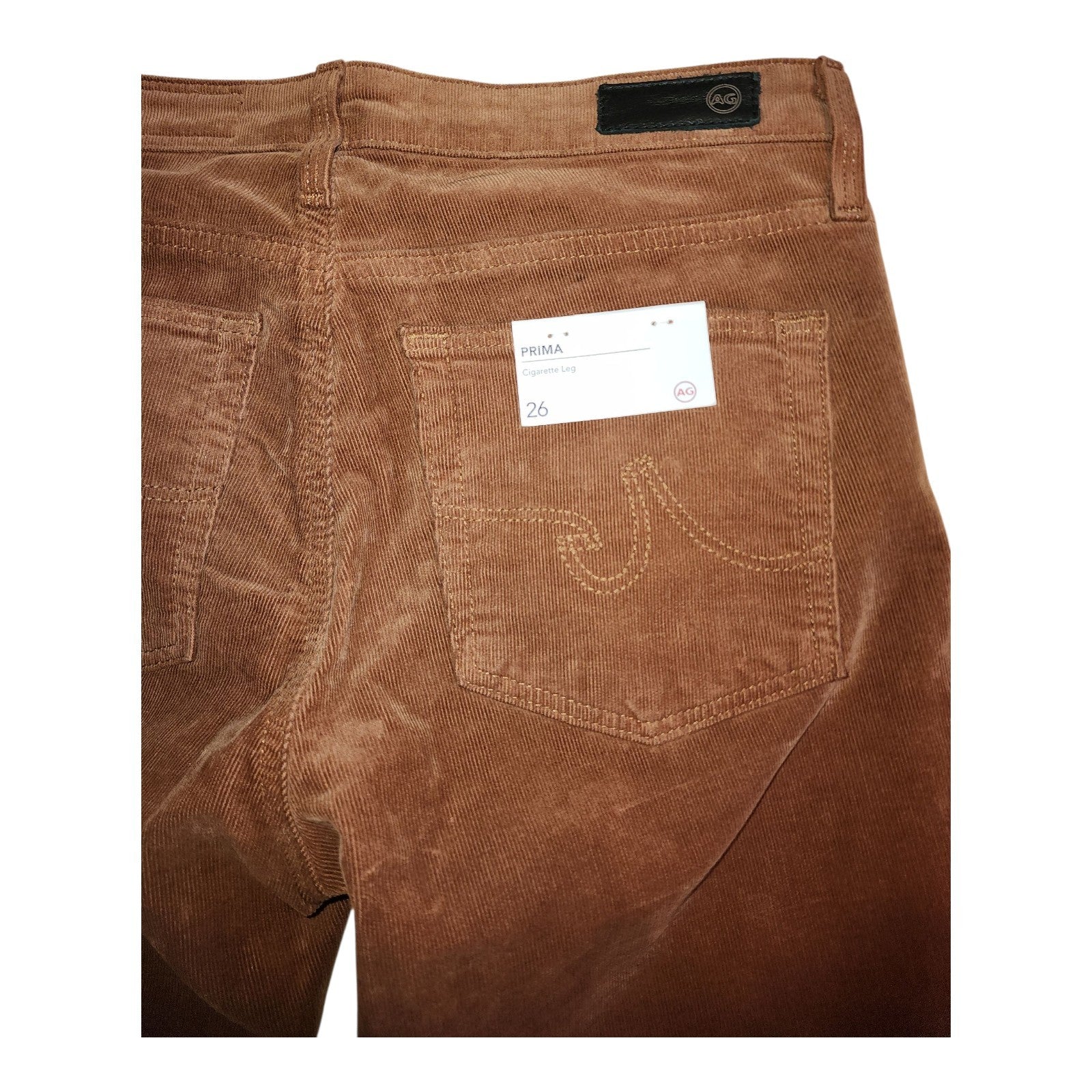 Brown corduroy pants with a brand label on a white background
