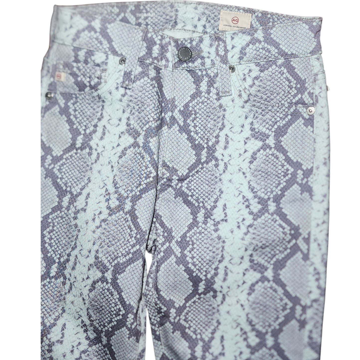 Light blue pants with snake print pattern on a white background